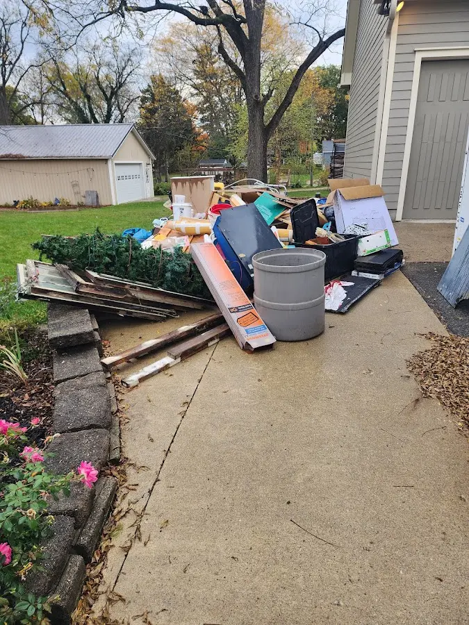 Dumpster being loaded with debris for Estate Cleanout Dumpster Rental in Kanab